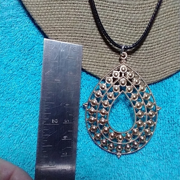 Goldtone intricate design teardrop necklace with black cord - Picture 4 of 4